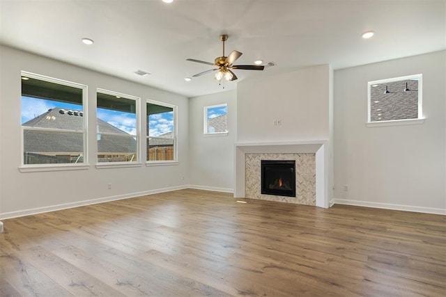 unfurnished living room featuring hardwood / wood-style flooring and ceiling fan