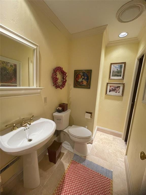 bathroom featuring tile patterned floors, ornamental molding, and toilet