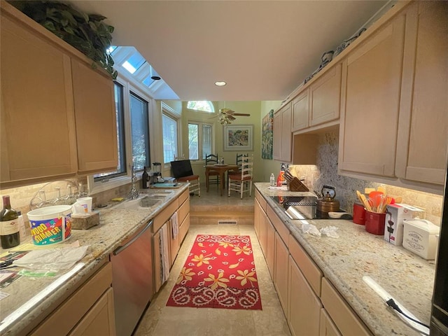 kitchen featuring dishwasher, light brown cabinetry, a skylight, and ceiling fan