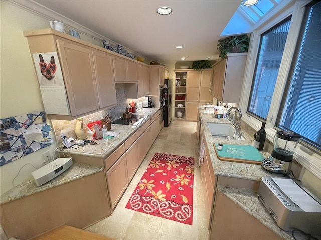 kitchen featuring backsplash, black electric stovetop, sink, ornamental molding, and double oven