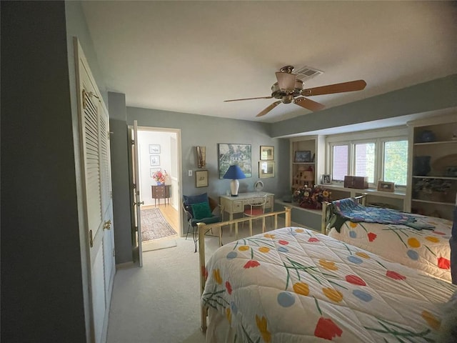 bedroom with light carpet, a closet, and ceiling fan