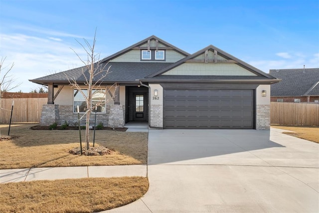 craftsman-style house featuring a garage and a front lawn