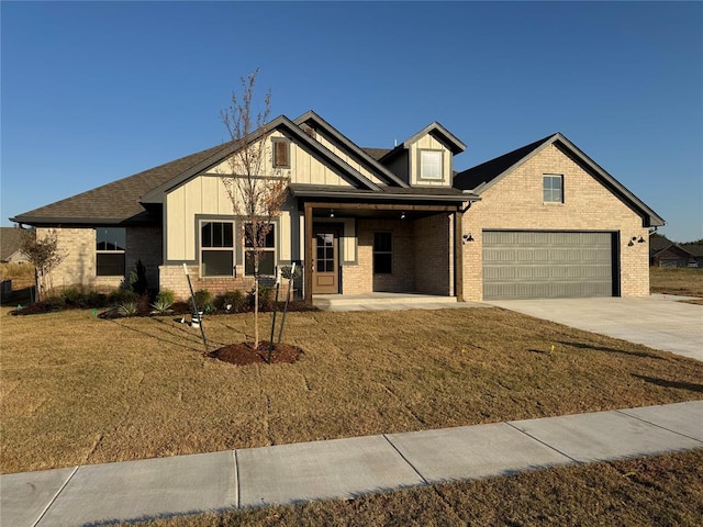 view of front of home with a garage and a front lawn