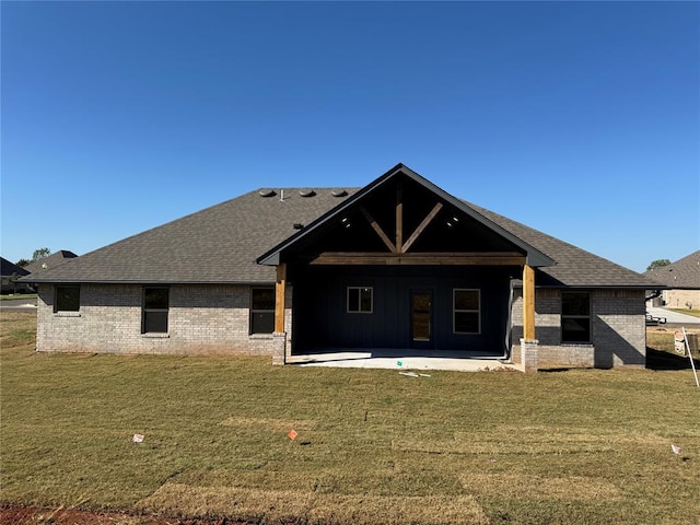 back of property featuring a lawn and a patio area