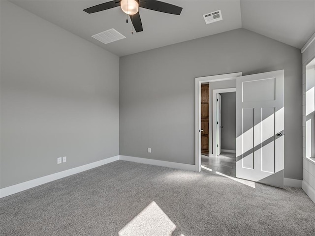 unfurnished room with ceiling fan, light carpet, and vaulted ceiling