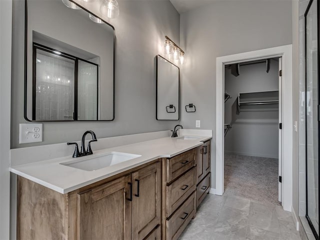 bathroom with a shower with door and vanity