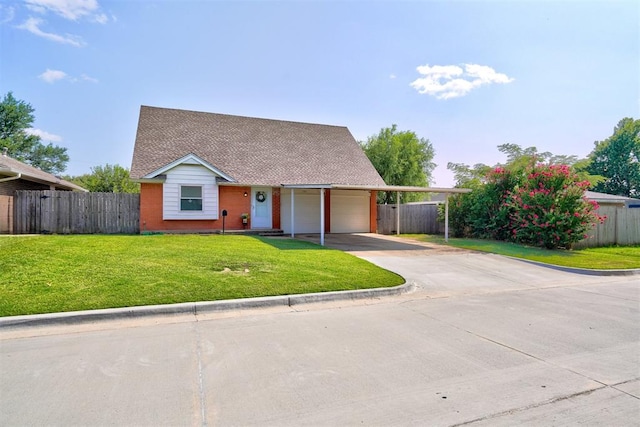 view of front of property with a front yard and a garage