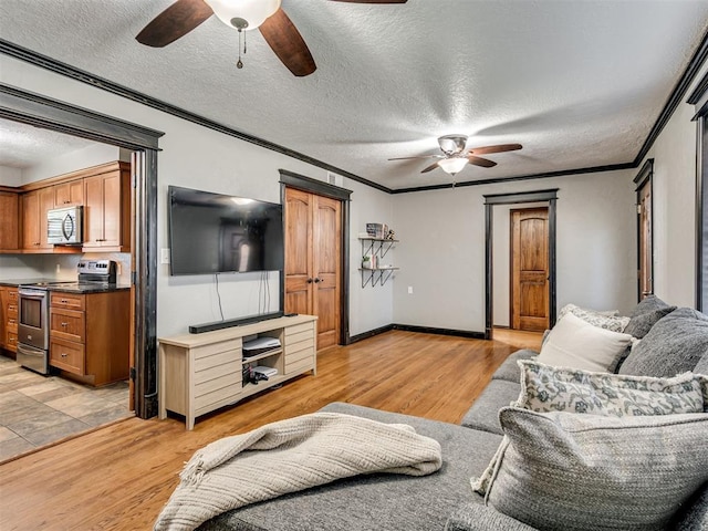 living room with a textured ceiling, light hardwood / wood-style flooring, and crown molding