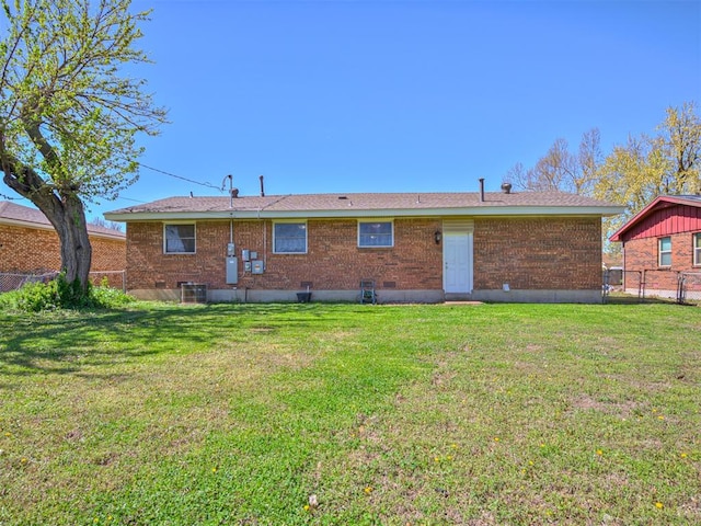 rear view of property with a yard