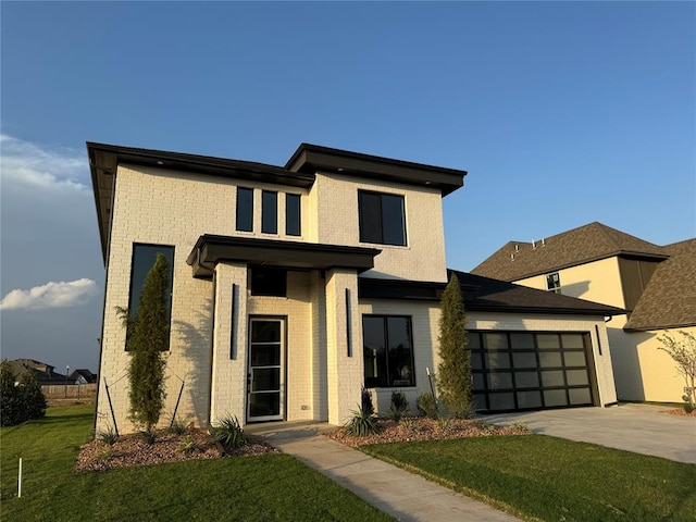 modern home featuring a garage and a front lawn