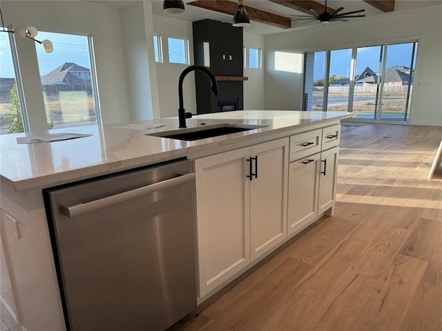 kitchen with white cabinetry, light hardwood / wood-style flooring, stainless steel dishwasher, and light stone counters