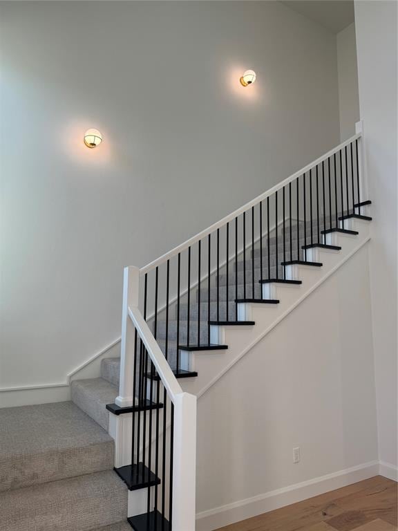 stairs with hardwood / wood-style flooring