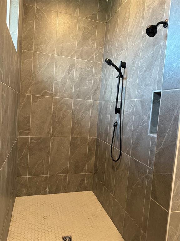 bathroom with tiled shower