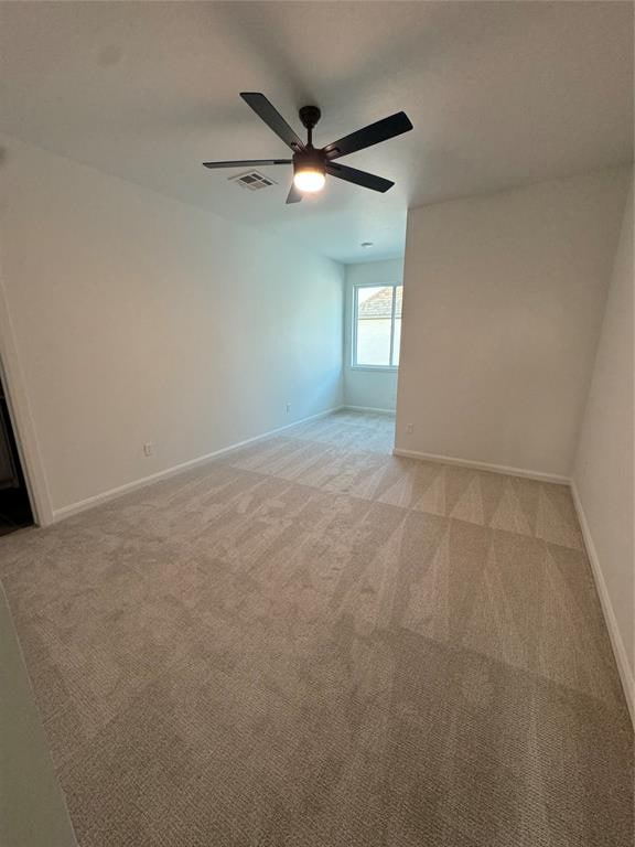 empty room with light carpet and ceiling fan