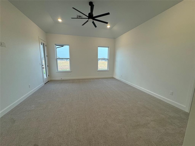 carpeted empty room featuring ceiling fan and vaulted ceiling