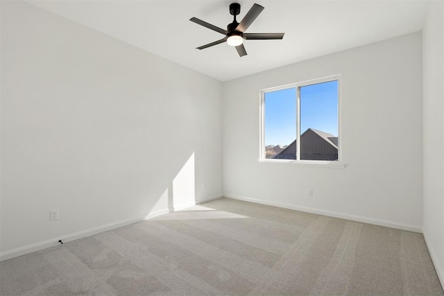 empty room featuring baseboards, carpet, and a ceiling fan