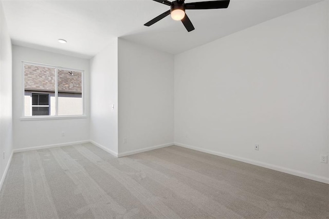 unfurnished room featuring ceiling fan, baseboards, and light carpet