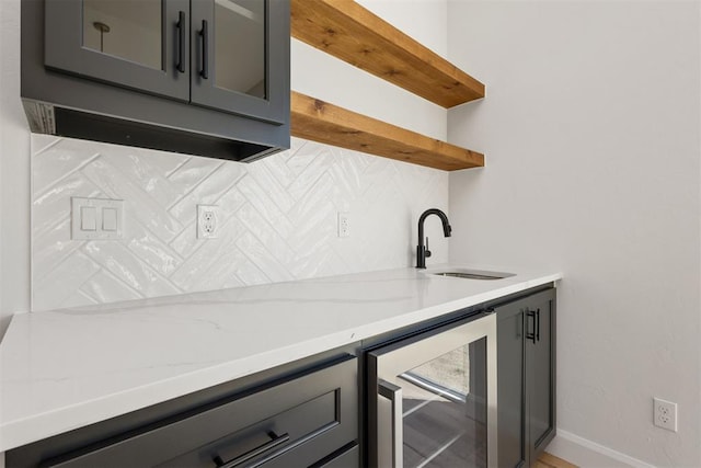 kitchen with a sink, open shelves, wine cooler, and gray cabinetry