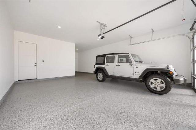 garage featuring recessed lighting, baseboards, and a garage door opener