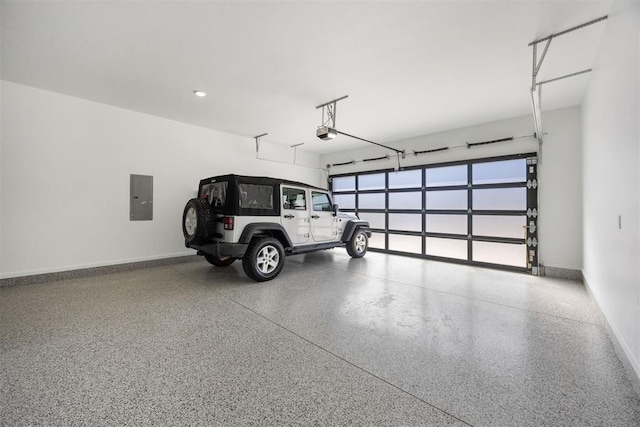 garage featuring electric panel, a garage door opener, and baseboards