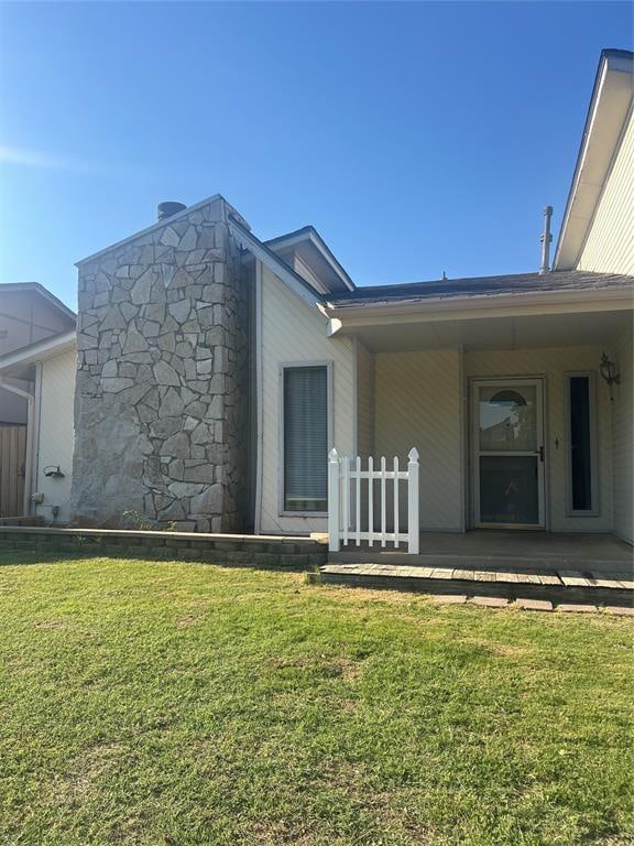 property entrance with a yard