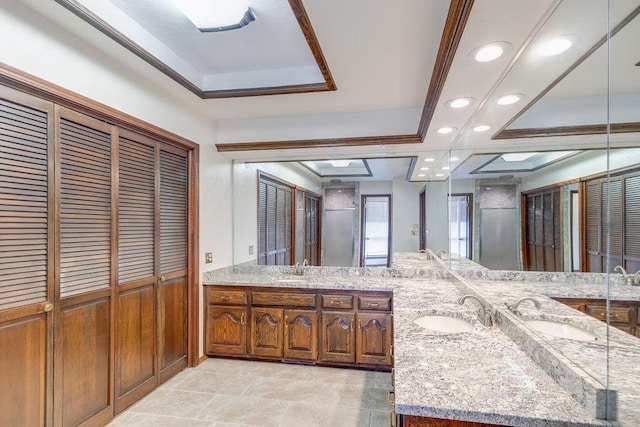 bathroom featuring vanity, a raised ceiling, and crown molding