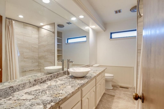 bathroom featuring a shower with shower curtain, tile patterned floors, vanity, and toilet