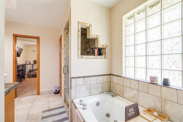 bathroom with tile patterned floors, vanity, and separate shower and tub