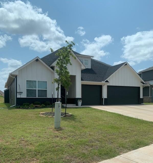 view of front of home with a garage and a front lawn