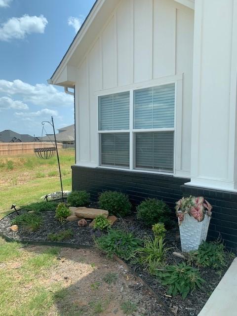 view of side of home with a yard