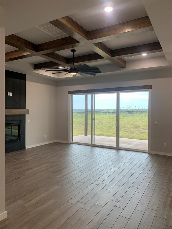 unfurnished living room with coffered ceiling, ceiling fan, beamed ceiling, and light hardwood / wood-style flooring