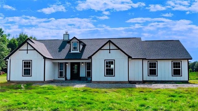 rear view of property with a lawn