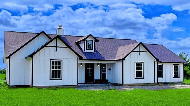 rear view of property featuring a yard