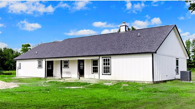 back of property featuring a yard and cooling unit