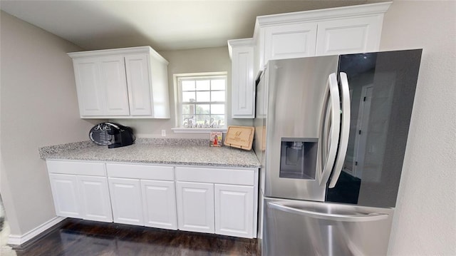 kitchen with white cabinets, dark hardwood / wood-style flooring, and stainless steel refrigerator with ice dispenser