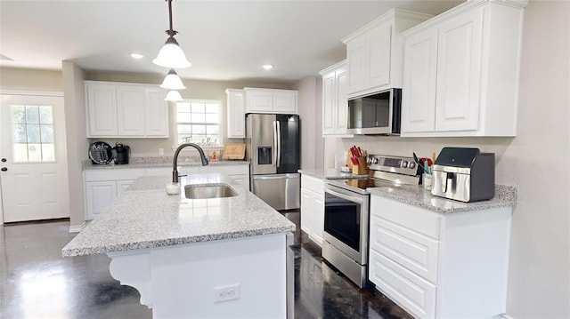 kitchen with pendant lighting, sink, white cabinets, and stainless steel appliances