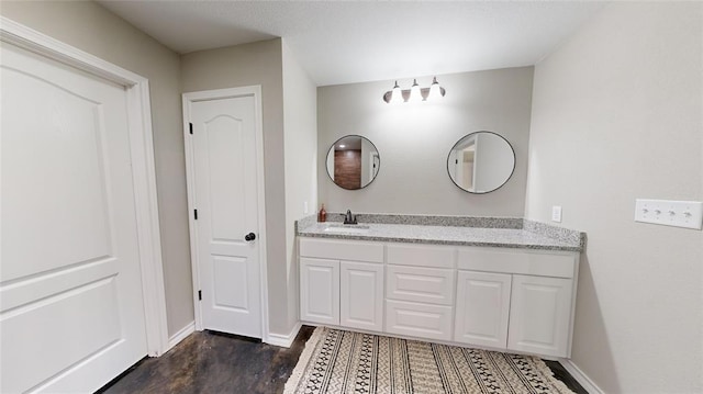 bathroom with vanity and wood-type flooring