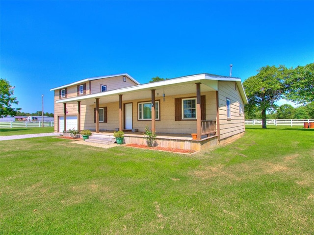 view of front of property with a front yard, a porch, and a garage