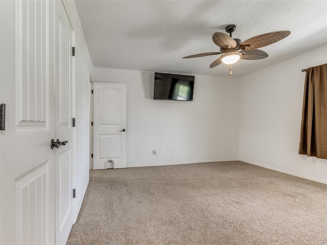 empty room featuring ceiling fan and carpet floors