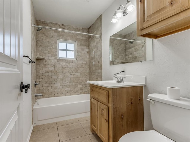 full bathroom featuring toilet, vanity, tile patterned floors, and tiled shower / bath