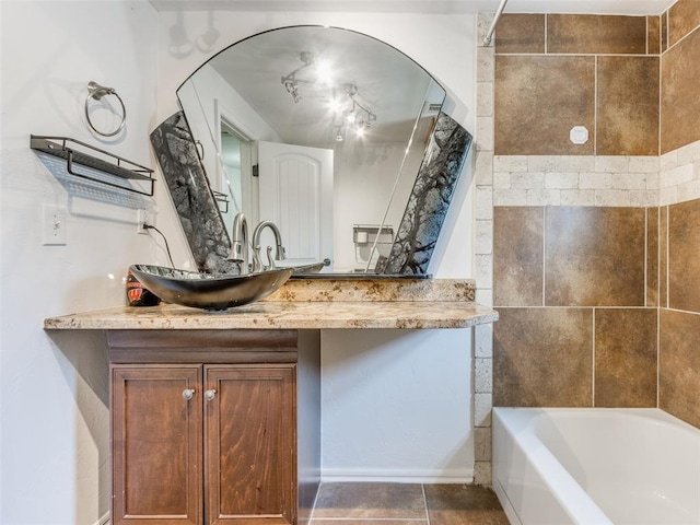 bathroom featuring vanity, tile patterned floors, and tiled shower / bath