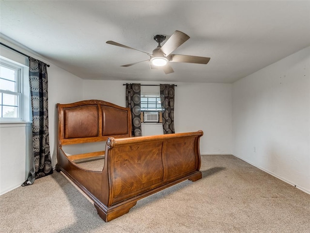 bedroom with light carpet, ceiling fan, and cooling unit