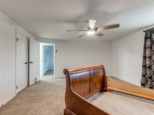 bedroom with ceiling fan and light carpet