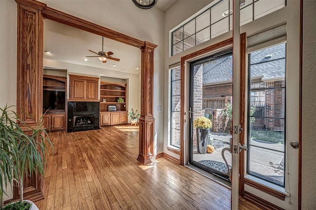 foyer entrance with ceiling fan, plenty of natural light, and light hardwood / wood-style floors