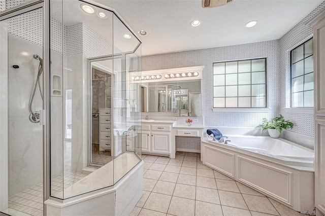 bathroom with tile patterned floors, vanity, and separate shower and tub