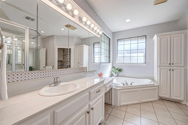 bathroom with shower with separate bathtub, vanity, and tile patterned floors