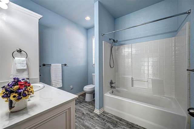 full bathroom featuring toilet, vanity,  shower combination, and hardwood / wood-style flooring