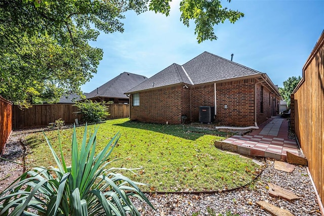 back of house featuring a lawn and central AC unit