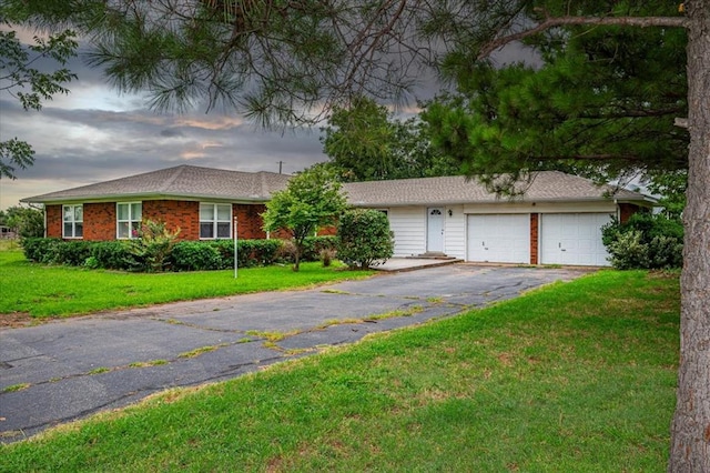 ranch-style house with a lawn and a garage