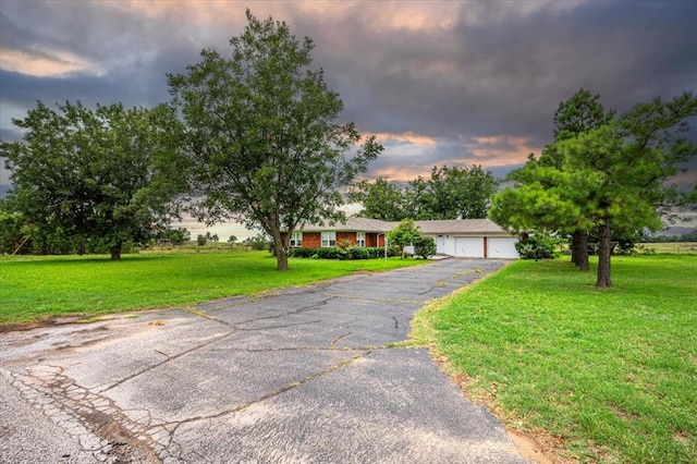 ranch-style home with a yard